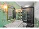 Beautifully decorated bathroom with a black tiled shower, marble vanity, and unique wallpaper at 6946 Woodstock Dr, Charlotte, NC 28210