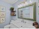 Stylish bathroom with marble vanity, decorative mirror, and modern fixtures at 6946 Woodstock Dr, Charlotte, NC 28210