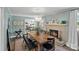Inviting dining room with a cozy fireplace, stylish light fixture, and access to the kitchen at 6946 Woodstock Dr, Charlotte, NC 28210