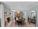 A light-filled dining room featuring hardwood floors, a fireplace, and elegant decorative details at 6946 Woodstock Dr, Charlotte, NC 28210