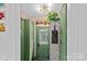 Charming entryway featuring vibrant wallpaper, built-in cabinets, and a unique, vintage-inspired design at 6946 Woodstock Dr, Charlotte, NC 28210