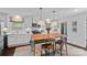 Eat-in kitchen with a wooden island, white cabinets, and modern appliances offers a functional layout at 6946 Woodstock Dr, Charlotte, NC 28210
