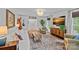 This bright and airy living room has hardwood floors, neutral paint and updated light fixtures at 6946 Woodstock Dr, Charlotte, NC 28210