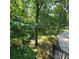 Scenic wooded lot, seen from the deck, showcasing a peaceful and private outdoor space at 695 Knollcrest Ne Dr, Concord, NC 28025