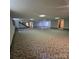 Spacious basement with patterned carpet and support beams offers potential for customization at 695 Knollcrest Ne Dr, Concord, NC 28025