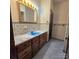 Traditional bathroom featuring blue tile, wood vanity, and an ornate mirror at 695 Knollcrest Ne Dr, Concord, NC 28025