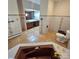 Well lit bathroom featuring a brown soaking tub and a matching toilet at 695 Knollcrest Ne Dr, Concord, NC 28025