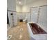 Well lit bathroom featuring a brown soaking tub and a matching toilet at 695 Knollcrest Ne Dr, Concord, NC 28025