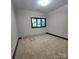 Smaller sized bedroom featuring carpet flooring, a window, and neutral walls at 695 Knollcrest Ne Dr, Concord, NC 28025