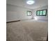 Large bedroom featuring plush carpet, two windows, and neutral walls at 695 Knollcrest Ne Dr, Concord, NC 28025
