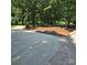 Wide paved driveway with ample parking space and mature trees at 695 Knollcrest Ne Dr, Concord, NC 28025