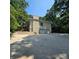 Rear exterior view of home with large garage and staircase at 695 Knollcrest Ne Dr, Concord, NC 28025