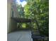 Backyard features a two-story brick home with stairs to elevated deck and attached garage at 695 Knollcrest Ne Dr, Concord, NC 28025