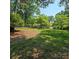 Spacious front yard with mature trees surrounding a beautiful home at 695 Knollcrest Ne Dr, Concord, NC 28025