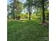 Expansive lawn and mature trees offer privacy and shade to this home at 695 Knollcrest Ne Dr, Concord, NC 28025