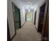 A well-lit hallway with plush carpeting and paneled doors, offering seamless transition between rooms at 695 Knollcrest Ne Dr, Concord, NC 28025