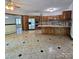 Open kitchen with marble-patterned tile flooring, wood cabinets, and modern stainless steel appliances creating an airy feel at 695 Knollcrest Ne Dr, Concord, NC 28025