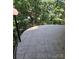 Expansive tiled patio framed by decorative lighting and a black railing, creating an inviting outdoor space at 695 Knollcrest Ne Dr, Concord, NC 28025