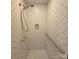 Modern shower with white patterned walls, hand shower, and a safety bar for enhanced accessibility and safety at 695 Knollcrest Ne Dr, Concord, NC 28025