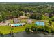 Aerial shot showcasing a community pool, tennis courts, lush greenery, and lakeside living at 705 Congressional Ln, Fort Mill, SC 29708