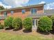This brick home features a small yard with mature landscaping and a secure backyard at 705 Congressional Ln, Fort Mill, SC 29708