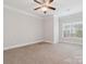 This carpeted bedroom features a ceiling fan, neutral walls, and a window for natural light at 705 Congressional Ln, Fort Mill, SC 29708