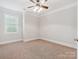 Bright bedroom featuring a ceiling fan, and neutral carpet, with window views at 705 Congressional Ln, Fort Mill, SC 29708