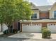 Charming townhome featuring a brick facade, two-car garage, and mature landscaping at 705 Congressional Ln, Fort Mill, SC 29708
