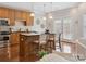 Cozy kitchen with wooden cabinets, granite countertop, pendant lighting and access to the living room at 705 Congressional Ln, Fort Mill, SC 29708
