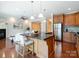 Gourmet kitchen with stainless appliances, granite counters, wood cabinets, and adjacent living area at 705 Congressional Ln, Fort Mill, SC 29708