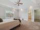 Light filled main bedroom with a ceiling fan, carpet, and a view to the bathroom at 705 Congressional Ln, Fort Mill, SC 29708