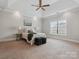 Spacious bedroom with tray ceiling, ceiling fan, carpet and large window at 705 Congressional Ln, Fort Mill, SC 29708