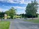 This view offers a calming pond reflecting the sky, a picturesque landscape, and a glimpse of community homes at 705 Congressional Ln, Fort Mill, SC 29708
