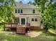 Back exterior of the house with a deck, stairs, and a well-maintained lawn at 7114 Kinsmore Ln, Charlotte, NC 28269
