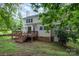 Back exterior of the house with a wooden deck and stairs leading to a spacious backyard at 7114 Kinsmore Ln, Charlotte, NC 28269