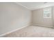 Bright bedroom features neutral walls and carpet with a window allowing natural light at 7114 Kinsmore Ln, Charlotte, NC 28269