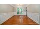 Inviting dining area featuring hardwood floors, decorative molding and a large window with a lush view at 7114 Kinsmore Ln, Charlotte, NC 28269
