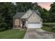 Charming home featuring a brick and vinyl facade, two car garage and an inviting front lawn at 7114 Kinsmore Ln, Charlotte, NC 28269