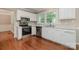 Modern kitchen features white cabinets, stainless steel appliances and lots of natural light at 7114 Kinsmore Ln, Charlotte, NC 28269