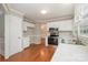 Efficient kitchen equipped with stainless steel appliances, white cabinetry, and durable floors at 7114 Kinsmore Ln, Charlotte, NC 28269