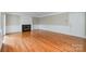 Bright living room with fireplace, hardwood floors and traditional architectural details at 7114 Kinsmore Ln, Charlotte, NC 28269