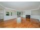 Spacious living room with fireplace, hardwood floors, and access to the deck at 7114 Kinsmore Ln, Charlotte, NC 28269