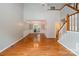 An elegant living room featuring hardwood floors, a staircase and an open view of the adjacent dining area at 7114 Kinsmore Ln, Charlotte, NC 28269
