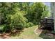 Lush backyard with stone pathway, beautiful landscaping, and wooden deck at 7121 Bidford Ct, Indian Land, SC 29707