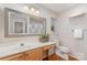 Bright bathroom with decorative mirror, wood floors, and large vanity at 7121 Bidford Ct, Indian Land, SC 29707
