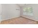 Well-lit bedroom with plush carpet and a large window offering natural light at 7121 Bidford Ct, Indian Land, SC 29707
