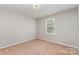Cozy bedroom featuring neutral walls, plush carpet, and a bright window at 7121 Bidford Ct, Indian Land, SC 29707