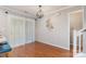 Bright dining area with hardwood floors, modern lighting, and a sliding glass door to the backyard at 7121 Bidford Ct, Indian Land, SC 29707