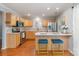 Bright kitchen featuring stainless steel appliances, wooden cabinetry, and breakfast bar with seating at 7121 Bidford Ct, Indian Land, SC 29707