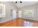 This room is light and airy with hardwood floors, tall ceilings, a large window, and a neutral paint color at 7121 Bidford Ct, Indian Land, SC 29707
